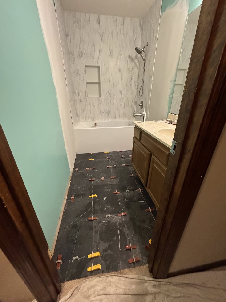 Bathroom flooring and tile installation in progress
