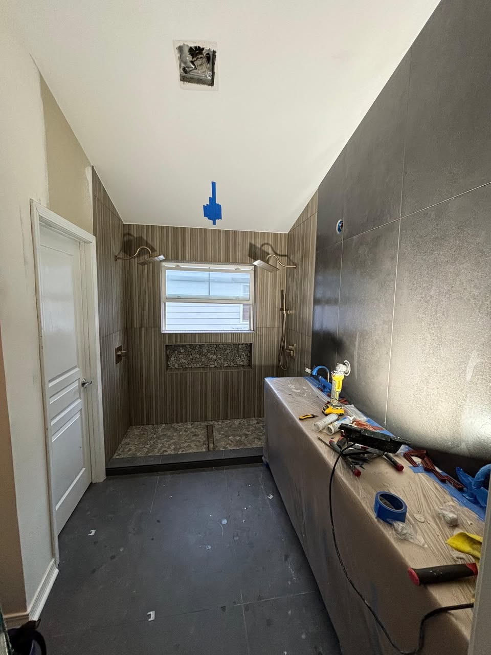 Custom shower tile installation in progress