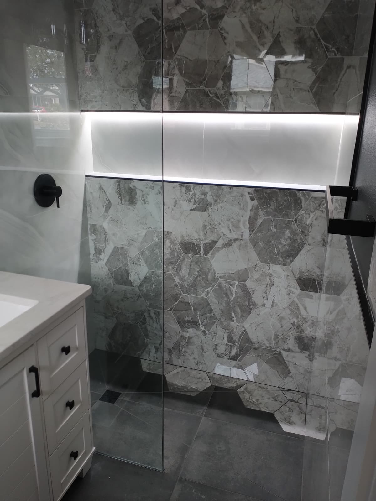 Hexagonal shower tile detail with built-in niche