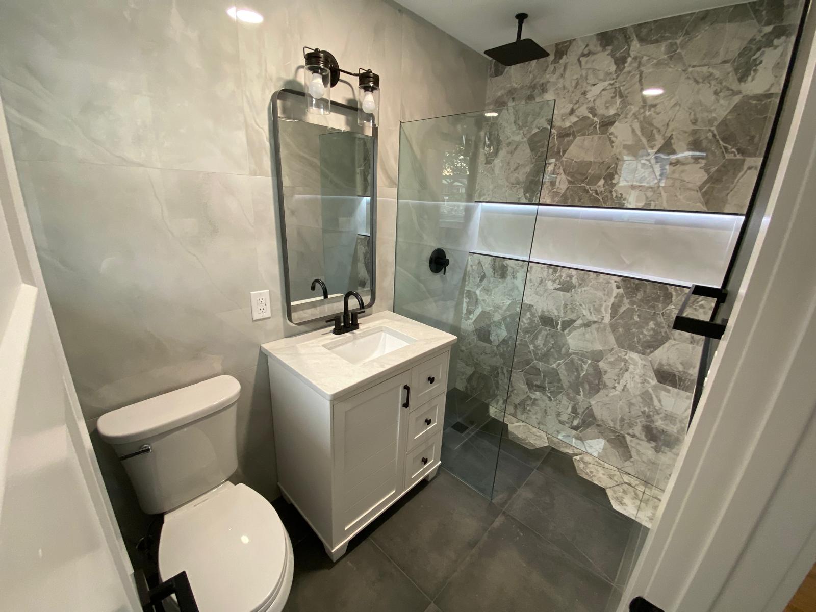 Modern bathroom renovation with new tile and fixtures